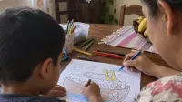 Madre e hijo coloreando juntos una actividad bíblica